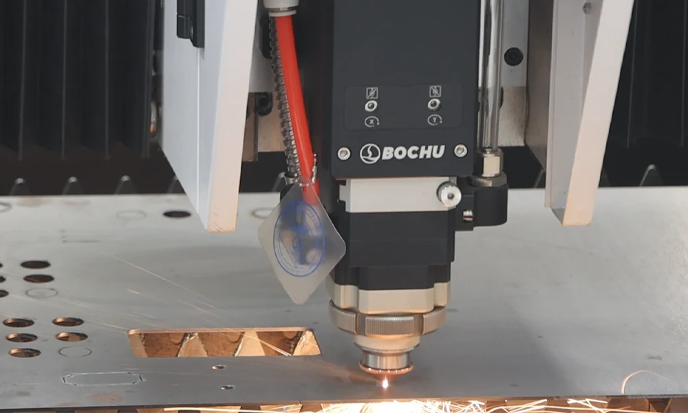 Close-up of a micro-precision fiber laser cutting system processing thin titanium foil in a cleanroom environment, showing the focused laser beam and minimal heat-affected zone