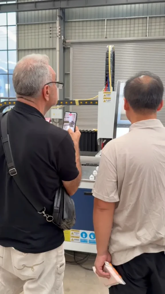 Customer visiting a laser cutting factory to inspect finished parts