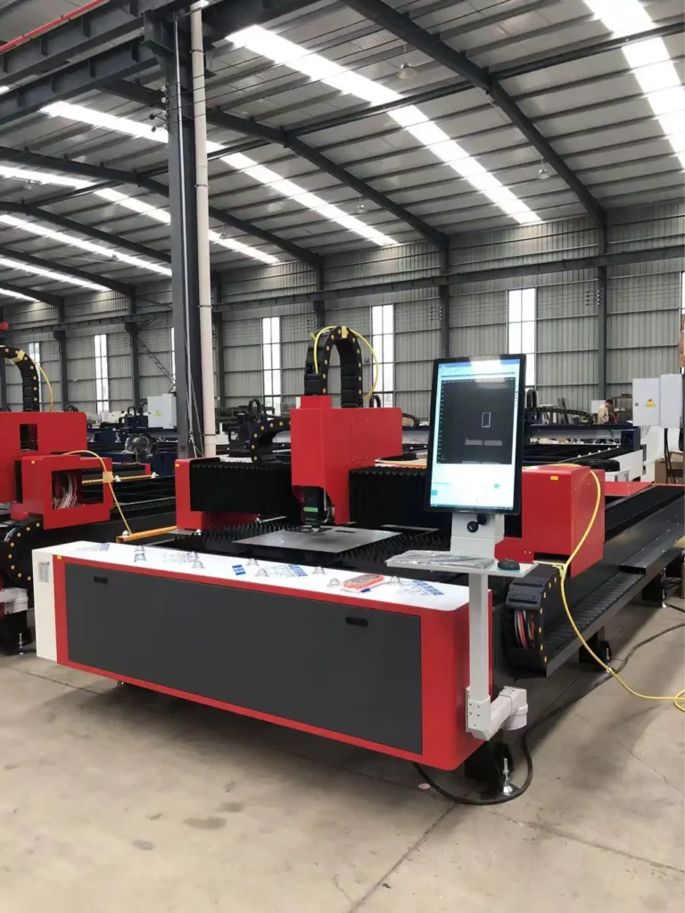 Fiber laser cutting machine in production in a fabrication workshop