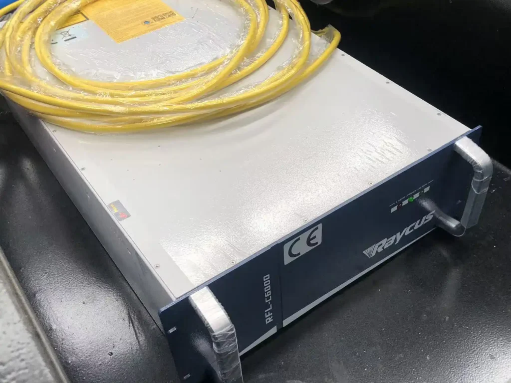 Industrial fiber laser source cabinet showing optical fiber connection