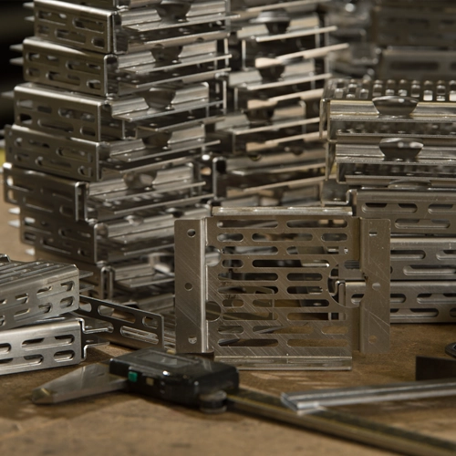 Stacked finished laser-cut steel parts on a pallet