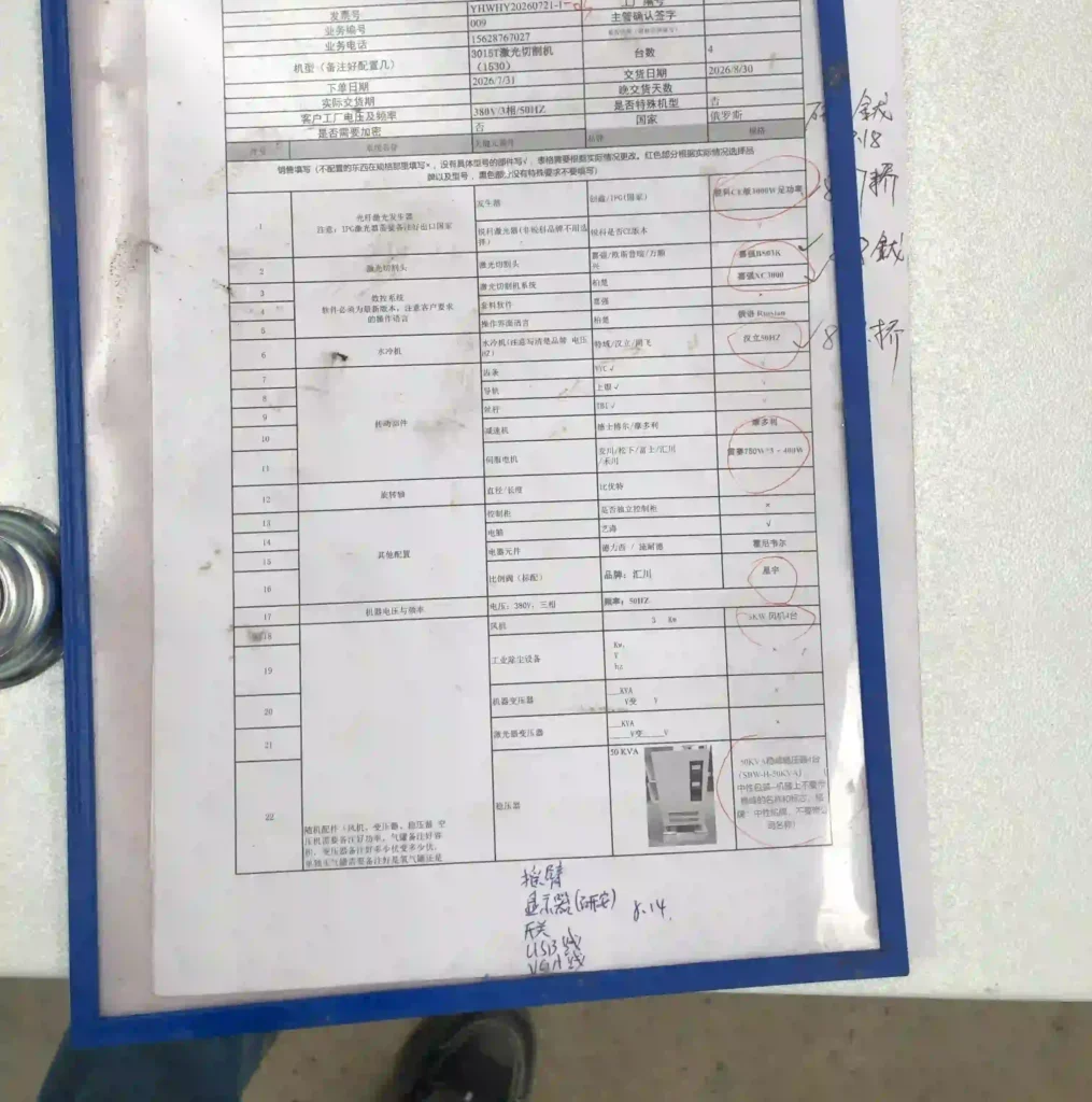 Stacked laser-cut sheet metal parts beside a paper invoice and packing slip on a workbench