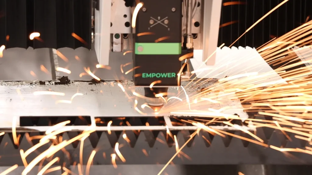 Fiber laser cutting machine cutting stainless steel in a fabrication workshop