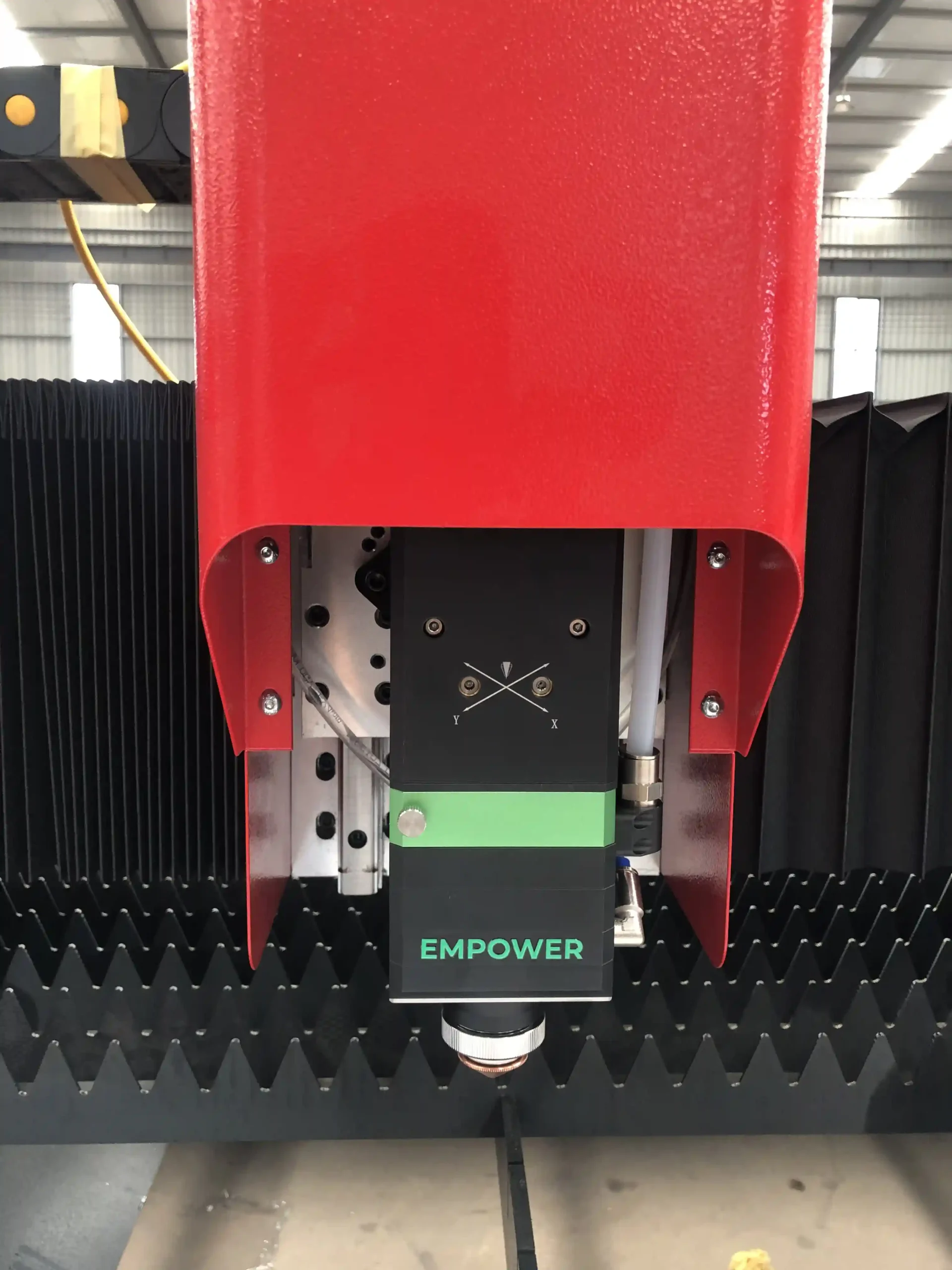 Fiber laser cutting head showing nozzle, protective window, and ceramic ring