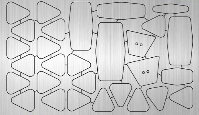 Irregular laser-cut parts held in place by micro-joints on a brushed stainless steel sheet