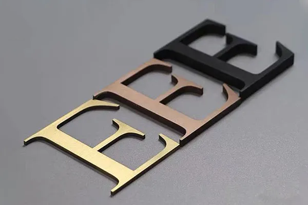 Sharp corner of a laser-cut stainless steel letter with clean edges