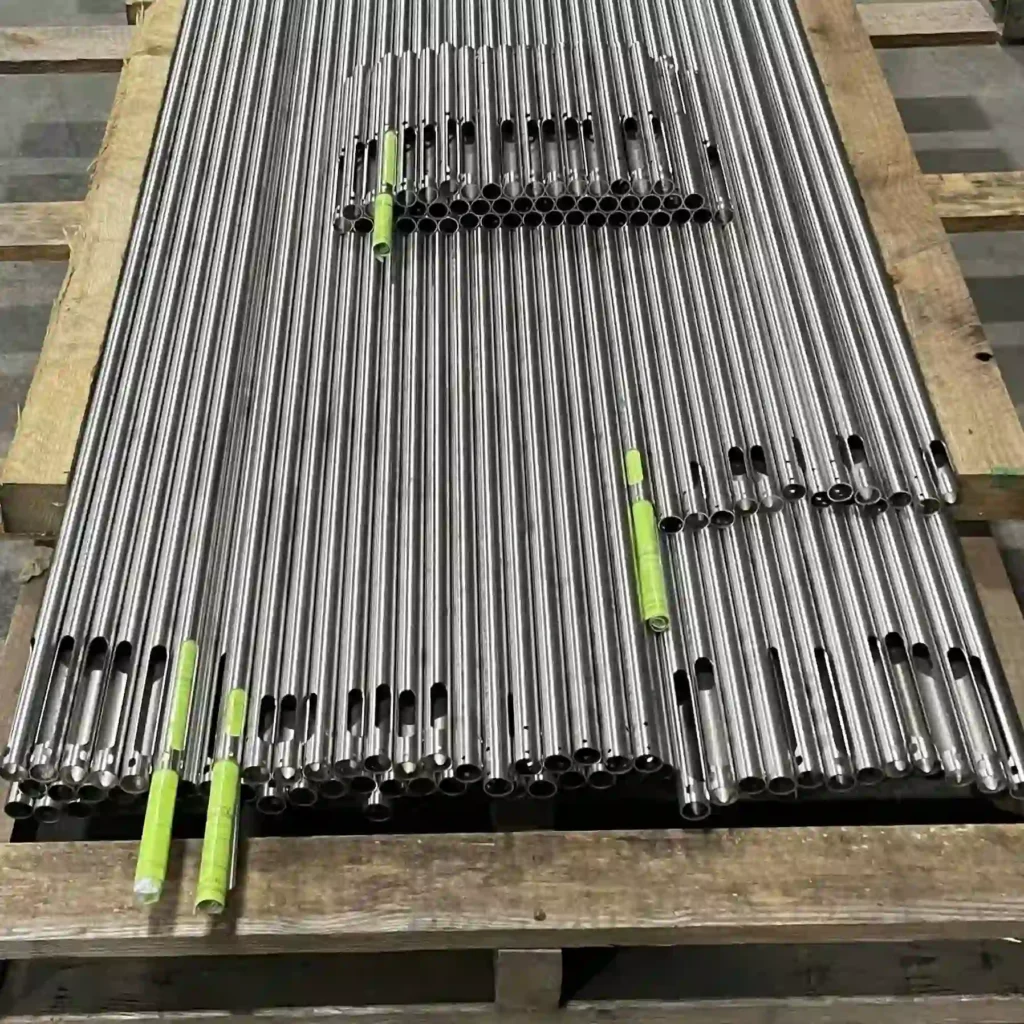 Stacked finished tube cut parts on pallets with barcode traceability tags