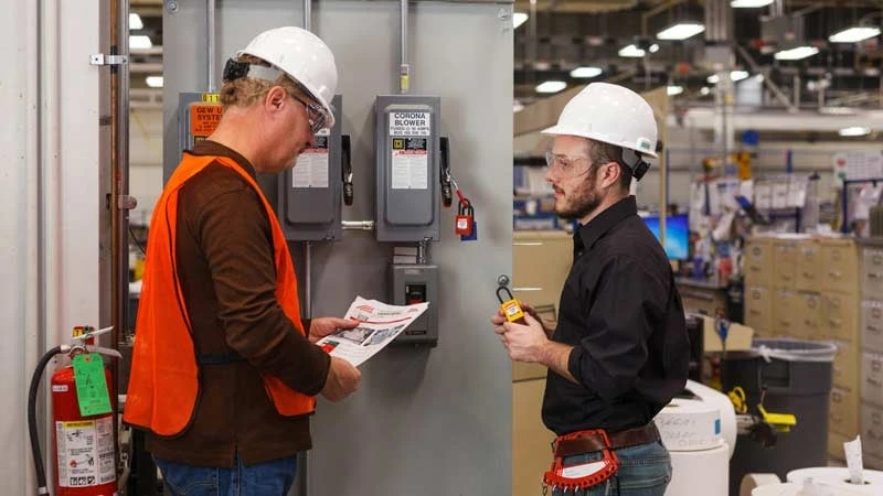 Engineers conducting on-site equipment audit and compliance verification for lease underwriting