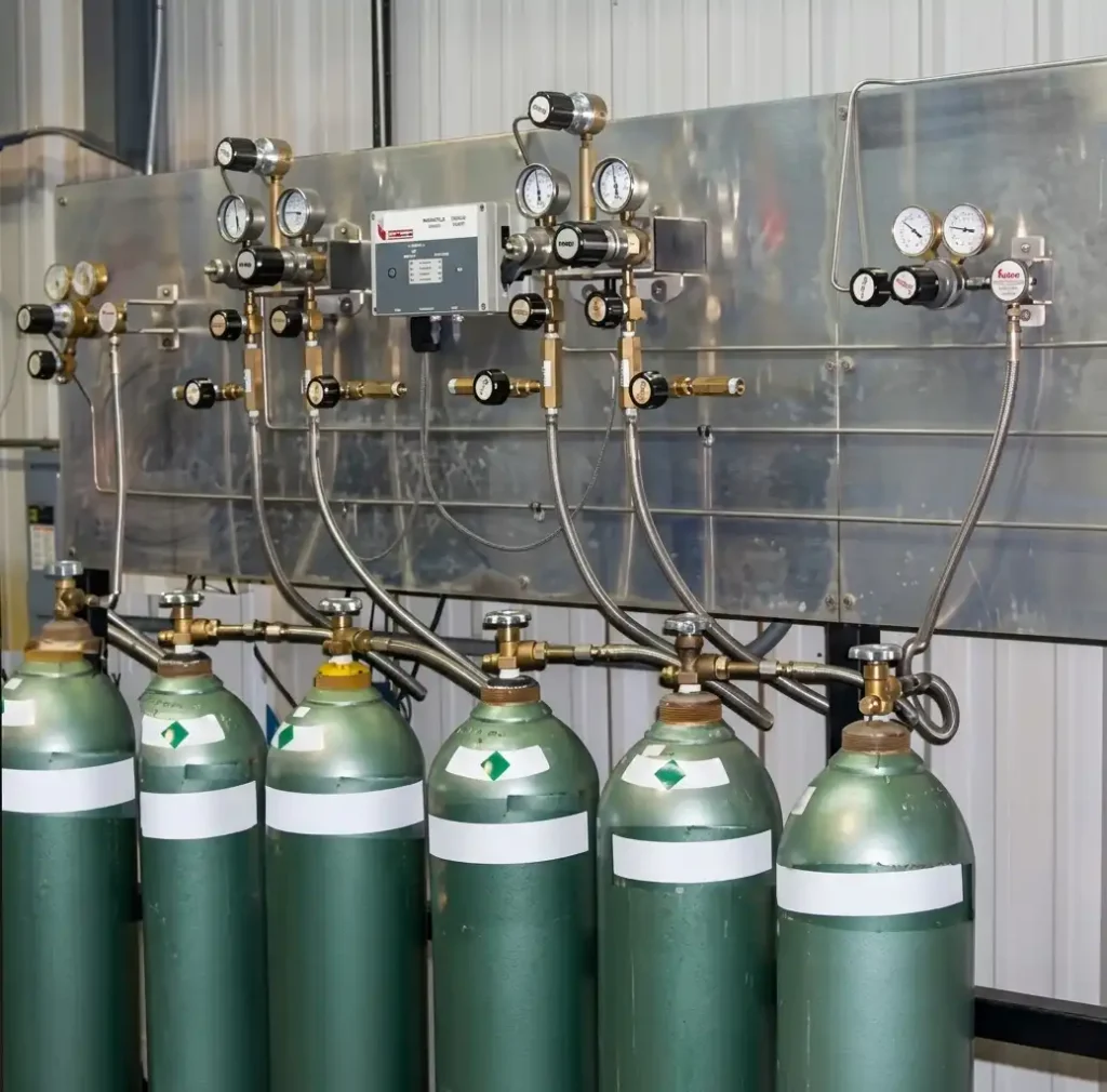 Cryogenic liquid dewars and high-pressure manifold station supplying assist gas to laser cutting cells