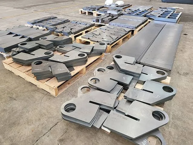 Wooden pallets stacked with precision laser-cut stainless steel parts showing bright, dross-free, oxide-free edges